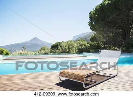 Lounge chair at poolside View Large Photo Image Stock Photo - Lounge chair at poolside. Fotosearch