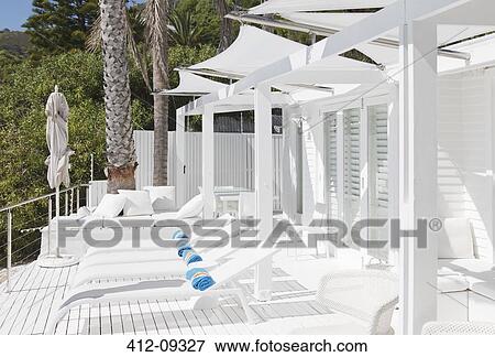 Lounge chairs and sofa on patio View Large Photo Image Stock Photo - Lounge chairs and sofa on patio. Fotosearch
