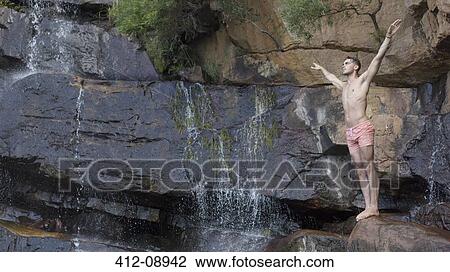 Man on rock preparing to dive View Large Photo Image Stock Image - Man on rock preparing to dive. Fotosearch