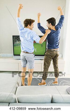 Men cheering and watching soccer game View Large Photo Image Stock Photo - Men cheering and watching soccer game. Fotosearch