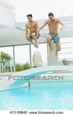 Men jumping into swimming pool View Large Photo Image Stock Image - Men jumping into swimming pool. Fotosearch