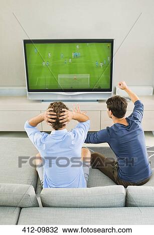 Men watching soccer game on sofa View Large Photo Image Stock Image - Men watching soccer game on sofa. Fotosearch