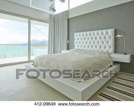 Modern bedroom overlooking ocean View Large Photo Image Stock Photo - Modern bedroom overlooking ocean. Fotosearch