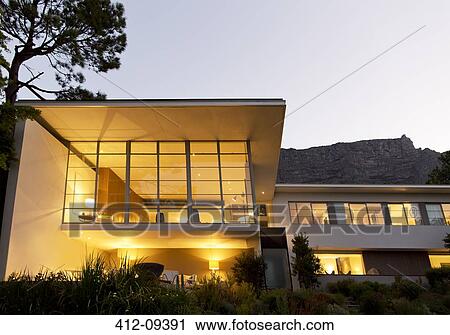 Modern house illuminated at night View Large Photo Image Stock Image - Modern house illuminated at night. Fotosearch