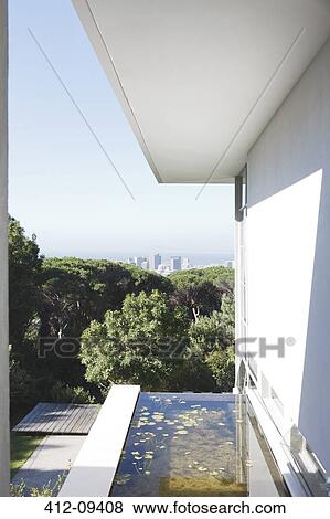 Stock Photo - Modern house overlooking city in distance. Fotosearch