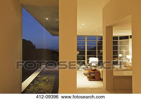 Stock Photograph - Modern house overlooking city in distance at night. Fotosearch