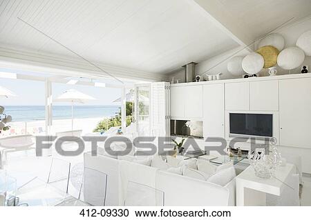 Modern living room overlooking beach and ocean View Large Photo Image Stock Image - Modern living room overlooking beach and ocean. Fotosearch