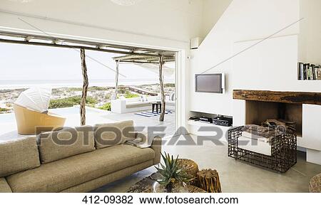 Modern living room overlooking ocean View Large Photo Image Stock Image - Modern living room overlooking ocean. Fotosearch