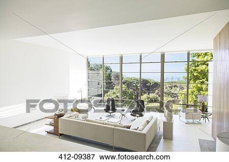 Modern living room overlooking trees View Large Photo Image Stock Photo - Modern living room overlooking trees. Fotosearch