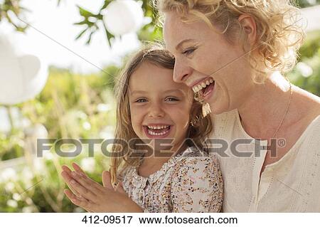 Mother and daughter laughing outdoors View Large Photo Image Stock Photo - Mother and daughter laughing outdoors. Fotosearch