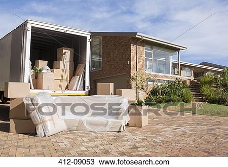 Stock Image - Moving van outside house. Fotosearch
