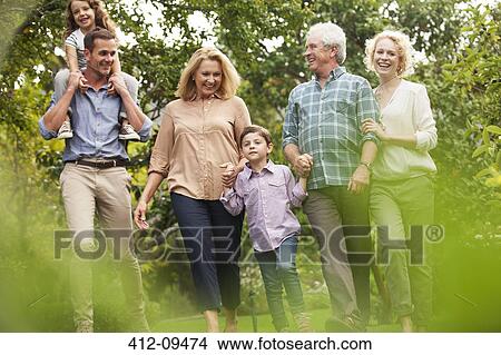 Multi-generation family walking in park View Large Photo Image Picture - Multi-generation family walking in park. Fotosearch
