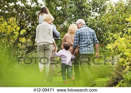 Stock Image - Multi-generation family walking in park. Fotosearch