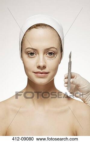 Plastic surgeon marking woman's face View Large Photo Image Stock Image - Plastic surgeon marking woman's face. Fotosearch