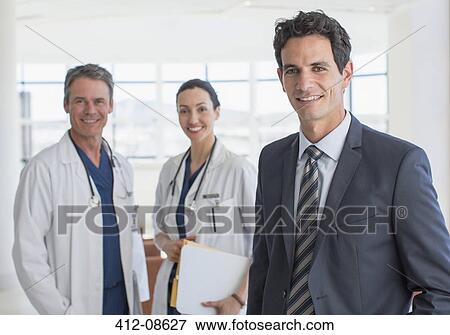 Portrait of confident businessman and doctors View Large Photo Image Stock Photo - Portrait of confident businessman and doctors. Fotosearch