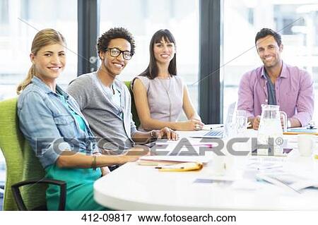 Portrait of smiling business people in office View Large Photo Image Stock Photo - Portrait of smiling business people in office. Fotosearch
