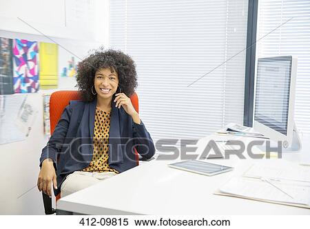 Portrait of smiling businesswoman in office View Large Photo Image Stock Photography - Portrait of smiling businesswoman in office. Fotosearch