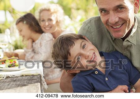 Stock Photo - Portrait of smiling father and son. Fotosearch