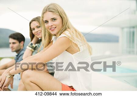 Portrait of smiling friends at poolside View Large Photo Image Picture - Portrait of smiling friends at poolside. Fotosearch