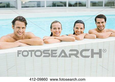 Portrait of smiling friends leaning at edge of swimming pool View Large Photo Image Stock Image - Portrait of smiling friends leaning at edge of swimming pool. Fotosearch