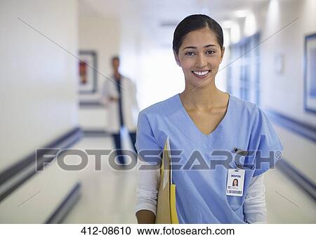 Portrait of smiling nurse in hospital corridor View Large Photo Image Stock Image - Portrait of smiling nurse in hospital corridor. Fotosearch