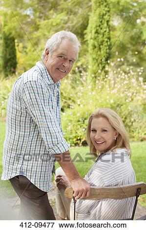 Portrait of smiling senior couple in garden View Large Photo Image Stock Photo - Portrait of smiling senior couple in garden. Fotosearch