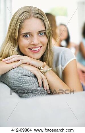 Portrait of smiling woman on sofa View Large Photo Image Picture - Portrait of smiling woman on sofa. Fotosearch