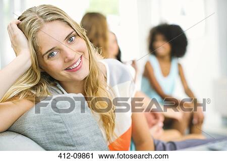 Portrait of smiling woman on sofa View Large Photo Image Stock Image - Portrait of smiling woman on sofa. Fotosearch