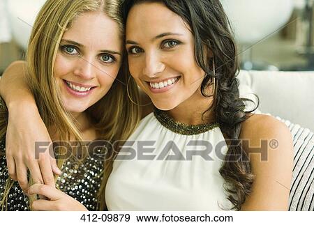 Portrait of smiling women hugging View Large Photo Image Stock Photo - Portrait of smiling women hugging. Fotosearch