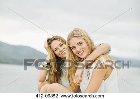 Portrait of smiling women outdoors View Large Photo Image Stock Image - Portrait of smiling women outdoors. Fotosearch
