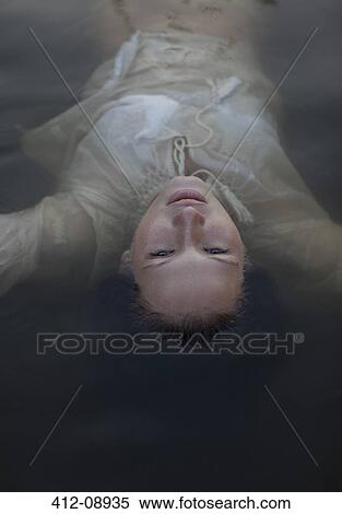 Serene woman floating in lake View Large Photo Image Stock Photography - Serene woman floating in lake. Fotosearch
