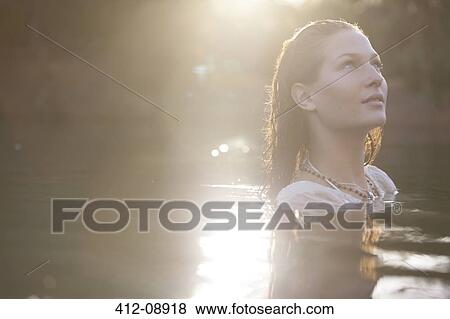 Serene woman in lake View Large Photo Image Stock Photo - Serene woman in lake. Fotosearch