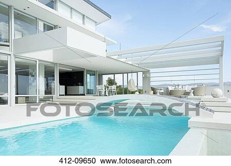 Stock Image - Swimming pool and modern house. Fotosearch