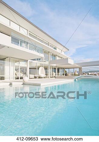 Swimming pool and modern house View Large Photo Image Stock Image - Swimming pool and modern house. Fotosearch