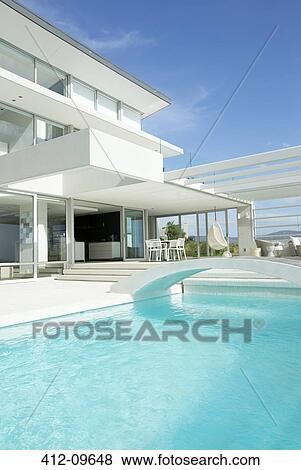 Swimming pool and modern house View Large Photo Image Stock Photo - Swimming pool and modern house. Fotosearch