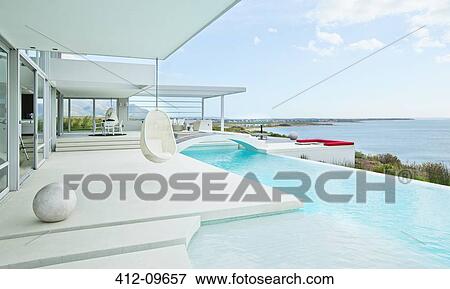 Swimming pool and modern house View Large Photo Image Stock Photo - Swimming pool and modern house. Fotosearch