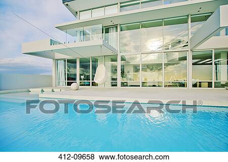 Swimming pool and modern house View Large Photo Image Stock Photo - Swimming pool and modern house. Fotosearch