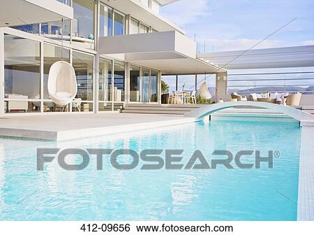 Swimming pool and modern house View Large Photo Image Stock Photograph - Swimming pool and modern house. Fotosearch