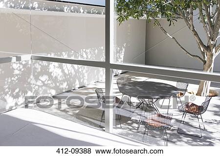 Table and chairs in courtyard View Large Photo Image Stock Photo - Table and chairs in courtyard. Fotosearch
