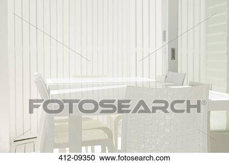 Table and chairs in white dining room View Large Photo Image Stock Image - Table and chairs in white dining room. Fotosearch
