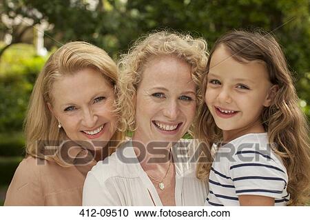 Three generations of women smiling outdoors View Large Photo Image Stock Image - Three generations of women smiling outdoors. Fotosearch