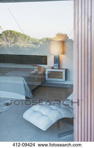 View of modern bedroom through window View Large Photo Image Picture - View of modern bedroom through window. Fotosearch