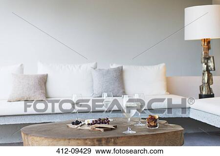 Wine and cheese on coffee table in modern living room View Large Photo Image Stock Photo - Wine and cheese on coffee table in modern living room. Fotosearch