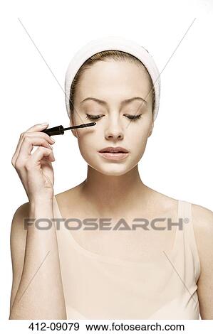 Woman applying mascara View Large Photo Image Stock Photo - Woman applying mascara. Fotosearch