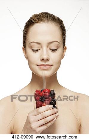 Woman drinking glass of berries View Large Photo Image Stock Image - Woman drinking glass of berries. Fotosearch