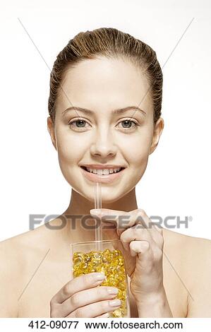 Woman drinking glass of vitamins View Large Photo Image Stock Photo - Woman drinking glass of vitamins. Fotosearch