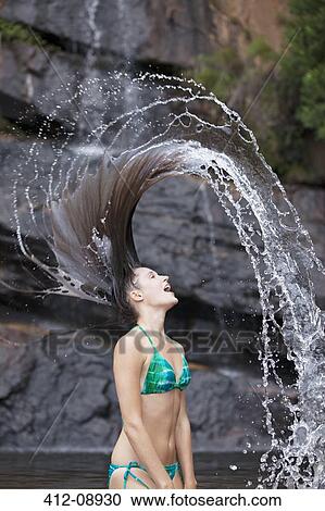Woman flipping hair in water View Large Photo Image Stock Image - Woman flipping hair in water. Fotosearch