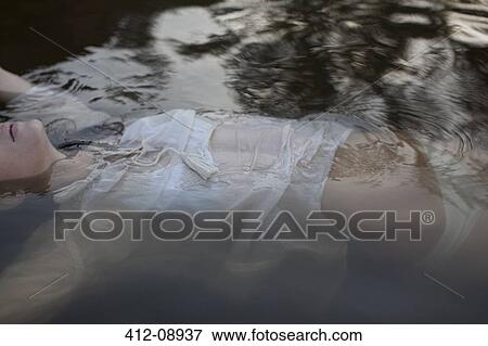 Woman floating in lake View Large Photo Image Stock Photo - Woman floating in lake. Fotosearch
