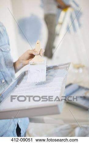 Woman holding paint tray with blue paint View Large Photo Image Stock Image - Woman holding paint tray with blue paint. Fotosearch