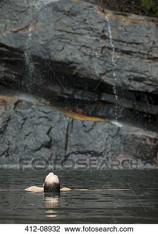 Stock Image - Woman swimming in pool. Fotosearch